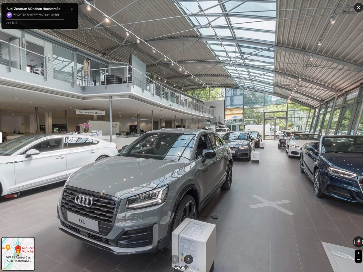 A modern car dealership with an impressive glass facade and a variety of displayed vehicles. This 360° shot offers a comprehensive view of the stylish and well-structured dealership, ideal for Google Business and the company website.