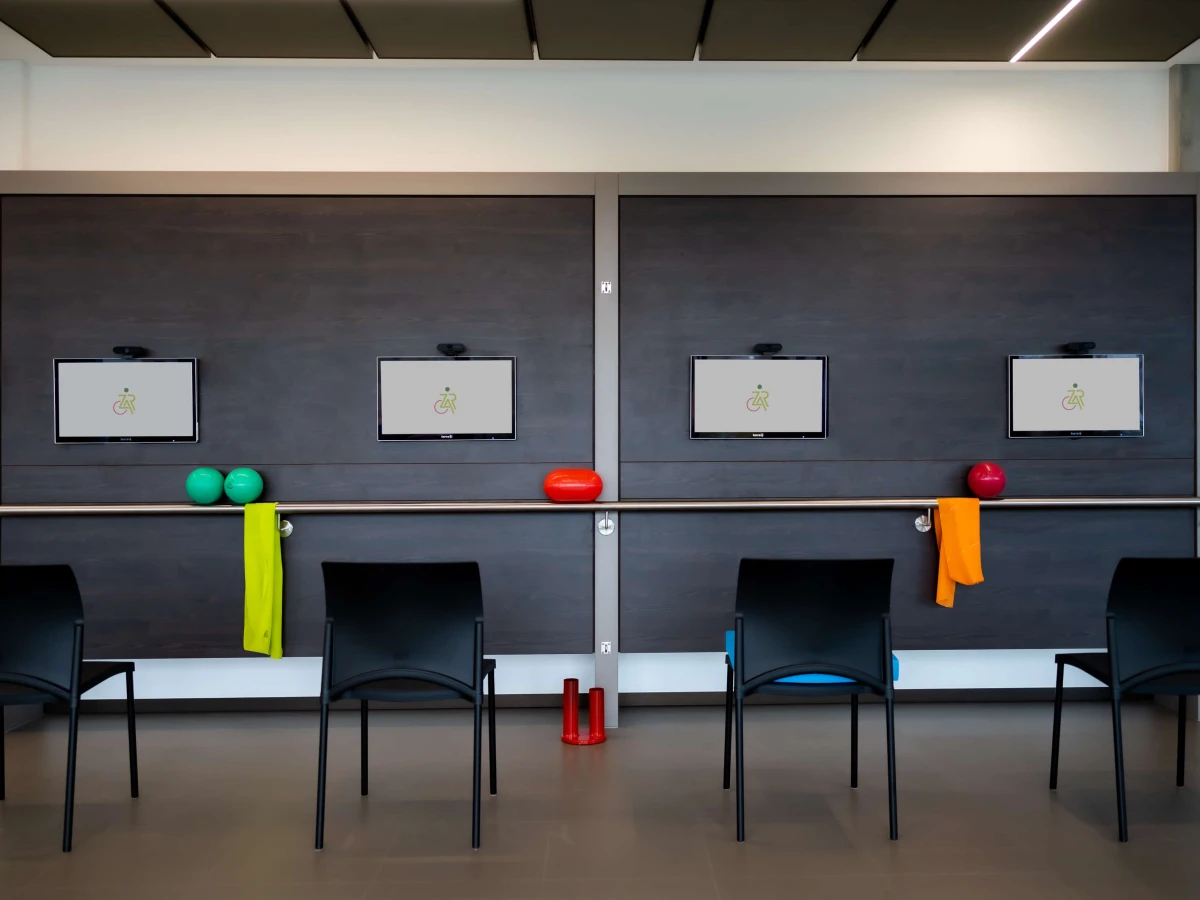 A modern training area with screens, colorful fitness equipment, and black chairs. This image showcases the advanced facilities and thoughtful design of the space, ideal for presenting training opportunities on the corporate website and in brochures.